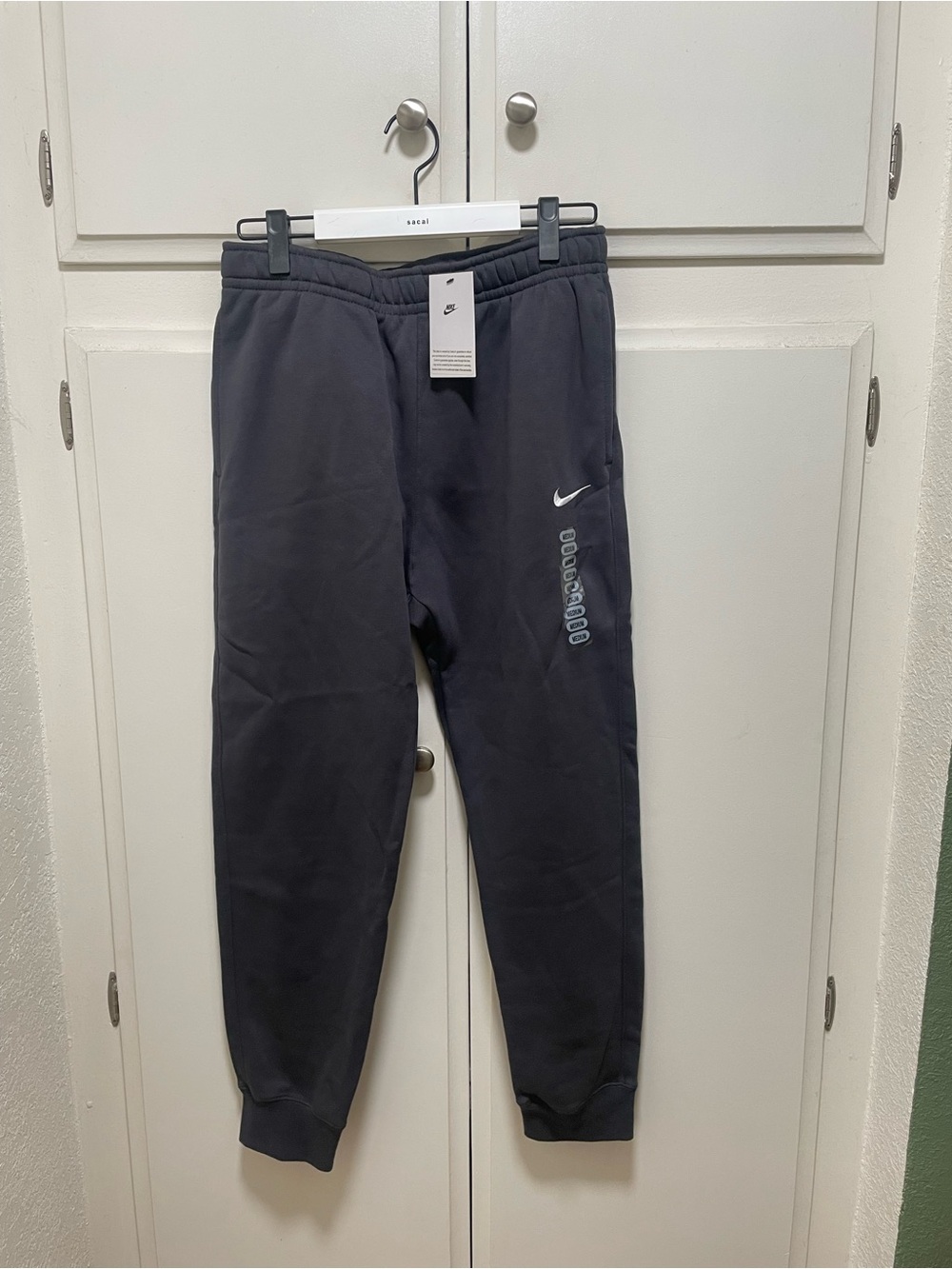 Nike charcoal gray joggers with white logo